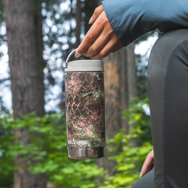 12oz-tkwide-with-cafe-cap-mossy-oak-d3 12oz_tumbler_mossyoak_rainbowtrout_hand_closeup_square.jpg