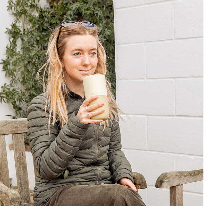 16oz-rise-tumbler-x7 16oz_rise_tumbler_wax_yellow_woman_seat_outside_square.jpg